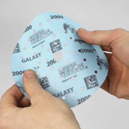 Mirka Galaxy Finishing Pads in Hand Being Flexed