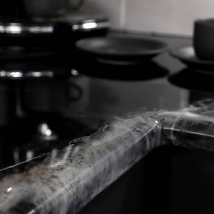 GlassCast Cosmic Black Granite Resin Countertop with Coffee Cups Blurry
