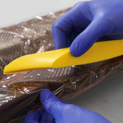 Positioning cured silicone intensifier wing root inserts on a UAV fuselage