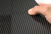High Strength Carbon Fiber Sheet in Hand Closeup Thumbnail