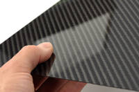 High Strength Carbon Fiber Sheet in Hand with Reflection Thumbnail