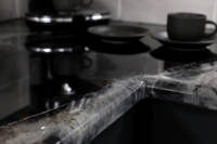 GlassCast Cosmic Black Granite Resin Countertop with Coffee Cups Blurry Thumbnail